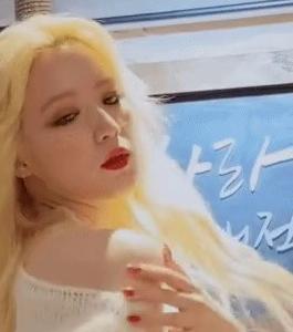 (G)I-DLE takes down their shoes and exposes their pale shoulders, with a sultry look in their eyes